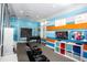 Community game room, featuring a foosball table, gaming chairs, and mounted televisions at 7572 Sunny Dreams Ln, Kissimmee, FL 34747