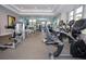 Well-equipped community fitness center with modern exercise machines and ample natural light at 7572 Sunny Dreams Ln, Kissimmee, FL 34747