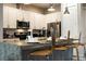 Bright eat-in kitchen with stainless steel appliances, granite countertops, breakfast bar at 7572 Sunny Dreams Ln, Kissimmee, FL 34747