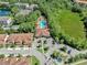 Aerial view of community pool, clubhouse, and lush landscaping in a desirable neighborhood at 8215 Roseville Blvd, Davenport, FL 33896