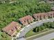 Aerial view of townhomes showcasing clay tile roofs in a well-maintained neighborhood at 8215 Roseville Blvd, Davenport, FL 33896