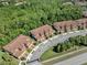 Aerial view of townhomes showcasing clay tile roofs in a well-maintained neighborhood at 8215 Roseville Blvd, Davenport, FL 33896