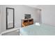 Comfortable bedroom boasts carpet flooring, a wall-mounted television, and neutral paint at 8215 Roseville Blvd, Davenport, FL 33896