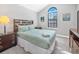Bright, neutral bedroom with a vaulted ceiling, large window, and comfortable furnishings at 8215 Roseville Blvd, Davenport, FL 33896