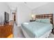 Cozy bedroom features carpet flooring, light green comforter and dark wood furniture at 8215 Roseville Blvd, Davenport, FL 33896
