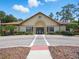Front view of clubhouse with manicured landscaping, tile roof and ample parking at 8215 Roseville Blvd, Davenport, FL 33896