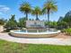 Community entrance featuring a beautiful fountain with palm trees at 8215 Roseville Blvd, Davenport, FL 33896