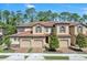Charming townhome with a tile roof and well-manicured landscaping at 8215 Roseville Blvd, Davenport, FL 33896