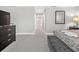 Bright hallway leading to bedrooms, decorated with a neutral color palette and framed artwork at 8215 Roseville Blvd, Davenport, FL 33896