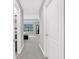 Hallway leading to the main bedroom showcasing carpet floors, neutral walls, and natural light at 8215 Roseville Blvd, Davenport, FL 33896