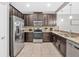 Modern kitchen features stainless steel appliances, granite countertops, and dark wood cabinets at 8215 Roseville Blvd, Davenport, FL 33896