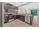 Open kitchen layout with modern appliances and granite countertops at 8215 Roseville Blvd, Davenport, FL 33896