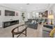 Open-concept living area showcasing tile floors, comfortable seating, entertainment center, and seamless flow to dining area at 8215 Roseville Blvd, Davenport, FL 33896