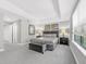 Spacious main bedroom with tray ceiling, carpeted floor, ample natural light, and a cozy seating area at 8215 Roseville Blvd, Davenport, FL 33896