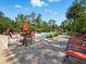 Community pool area with lounge chairs, tables, and beautiful landscaping at 8215 Roseville Blvd, Davenport, FL 33896
