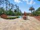 Outdoor community pool area with tropical landscaping and ample lounge seating at 8215 Roseville Blvd, Davenport, FL 33896