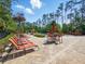 Community pool with lounge chairs and umbrellas, all amidst lush trees at 8215 Roseville Blvd, Davenport, FL 33896