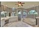 Bright bathroom featuring a large vanity, walk-in shower, and soaking tub with a half-moon window for natural light at 8713 S Bay Dr, Orlando, FL 32819