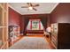 Bedroom with a large window seat, plush rug, and deep red paint at 8713 S Bay Dr, Orlando, FL 32819