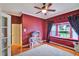 Bedroom with a cozy window seat, plush rug, and view into an adjoining room at 8713 S Bay Dr, Orlando, FL 32819