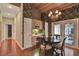 A kitchen dining area with a black wooden table and chairs near a white door and hardwood floors at 8713 S Bay Dr, Orlando, FL 32819