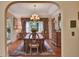 Dining room with a large wooden table, ornate chandelier, and large window with lush views at 8713 S Bay Dr, Orlando, FL 32819