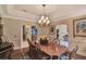 Formal dining room with hardwood floors, and decorative wainscoting and arched doorway details at 8713 S Bay Dr, Orlando, FL 32819