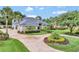 Beautiful one-story home features a circular driveway and mature landscaping for ultimate curb appeal at 8713 S Bay Dr, Orlando, FL 32819