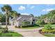 Stunning one-story home boasts a circular driveway and a manicured lawn with lush landscaping at 8713 S Bay Dr, Orlando, FL 32819