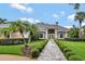Beautiful one-story home featuring mature landscaping and a stone walkway leading to the front door at 8713 S Bay Dr, Orlando, FL 32819