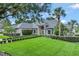 Charming one-story home boasts a manicured lawn and lush landscaping with mature trees at 8713 S Bay Dr, Orlando, FL 32819