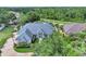 Aerial front exterior of residence with a view of beautiful yard and landscaping at 8713 S Bay Dr, Orlando, FL 32819