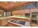 Kitchen with an island cooktop, wooden cabinets, stainless appliances, and hardwood floors at 8713 S Bay Dr, Orlando, FL 32819