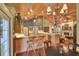 Bright kitchen featuring light wood cabinets, an island cooktop, a breakfast bar, and hardwood floors at 8713 S Bay Dr, Orlando, FL 32819