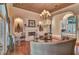Elegant living room with a fireplace, arched doorways, and a view of the grand foyer at 8713 S Bay Dr, Orlando, FL 32819