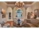 Elegant living room boasts marble flooring, arched doorways, and a view of the grand foyer at 8713 S Bay Dr, Orlando, FL 32819
