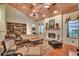 Inviting living room featuring vaulted wood ceilings, a fireplace, built-in shelving, and lots of natural light at 8713 S Bay Dr, Orlando, FL 32819