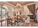 Elegant living room with wood floors, arched doorways, and a view of the grand foyer at 8713 S Bay Dr, Orlando, FL 32819