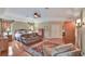 The main bedroom features hardwood floors, a bed, a sofa and sitting area with decor at 8713 S Bay Dr, Orlando, FL 32819