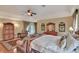 Main bedroom with a large bed, hardwood floors, sitting area and a ceiling fan at 8713 S Bay Dr, Orlando, FL 32819