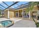 Spacious outdoor patio area with a pool and spa, featuring comfortable seating and a covered area at 8713 S Bay Dr, Orlando, FL 32819