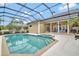 Spacious screened-in pool and spa area with a well-manicured yard, ideal for outdoor entertaining at 8713 S Bay Dr, Orlando, FL 32819