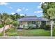 Back exterior view of property showing a large pool and mature landscaping at 8713 S Bay Dr, Orlando, FL 32819