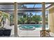 Beautiful view of a screened-in pool and spa area surrounded by lush landscaping, perfect for relaxation at 8713 S Bay Dr, Orlando, FL 32819