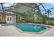 Inviting screened-in pool with a spa, offering a serene outdoor retreat with lush greenery at 8713 S Bay Dr, Orlando, FL 32819