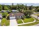 An aerial view of the gray house with a long driveway and well kept lawn at 896 Satin Leaf Cir, Ocoee, FL 34761