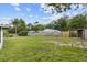 Wide shot of the backyard featuring a wooden fence and a shed at 896 Satin Leaf Cir, Ocoee, FL 34761