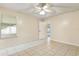 Bright bedroom with tile flooring, ceiling fan, and natural light from a large window at 896 Satin Leaf Cir, Ocoee, FL 34761