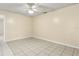 A well-lit bedroom featuring neutral walls and tile flooring throughout at 896 Satin Leaf Cir, Ocoee, FL 34761