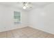 Bright, clean bedroom with tile floors, ceiling fan, and natural light at 896 Satin Leaf Cir, Ocoee, FL 34761